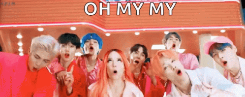 A Group Of Young People Are Standing Next To Each Other In Front Of A Sign That Says Oh My My . GIF