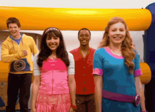 A Group Of Young People Standing In Front Of An Inflatable Bouncy House GIF