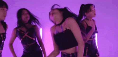 A Group Of Young Women Are Dancing In A Purple Room GIF