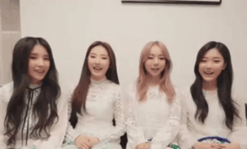 A Group Of Young Women Are Sitting Next To Each Other And Smiling GIF