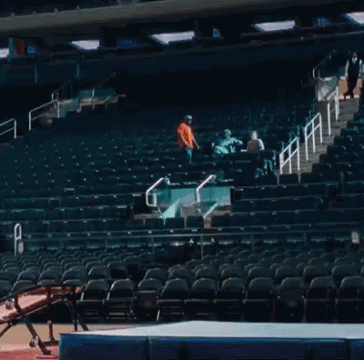A Gymnast Is Jumping Over A Mat In A Stadium GIF