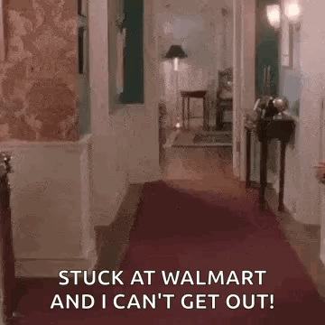 A Hallway With A Red Carpet And The Words `` Stuck At Walmart And I Can 'T Get Out '' GIF