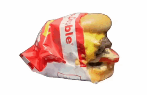 A Hamburger Is Wrapped In A Plastic Bag That Says Dole GIF