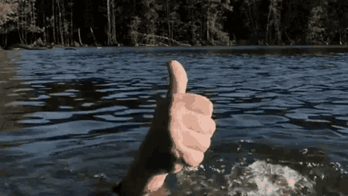A Hand Is Giving A Thumbs Up In The Water GIF
