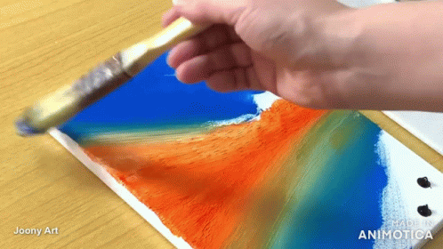 A Hand Is Holding A Brush Over A Piece Of Paper That Says ' Made In Animatica ' On It GIF