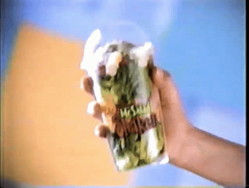 A Hand Is Holding A Mcdonald 'S Salad In A Plastic Cup GIF