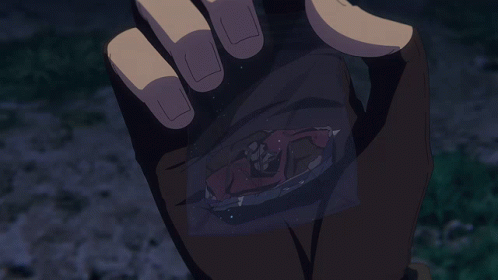 A Hand Is Holding A Piece Of Paper With A Picture Of A Person On It GIF