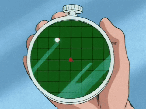 A Hand Is Holding A Watch That Shows A Red Triangle On The Screen GIF