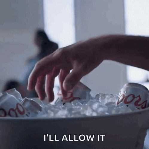 A Hand Is Reaching Into A Bucket Of Ice With A Can Of Coors In It GIF
