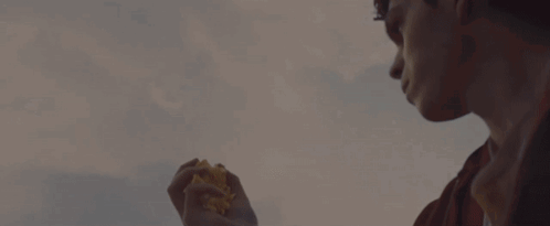 A Hand Is Reaching Out Towards A Flock Of Birds In The Sky GIF