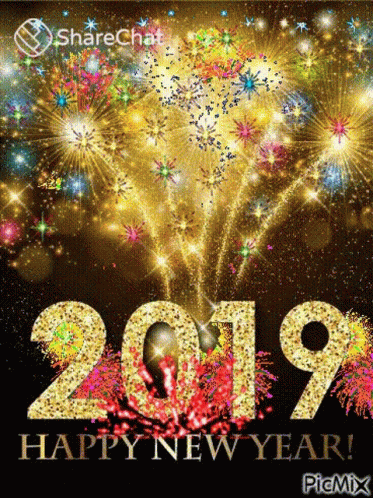 A Happy New Year Greeting Card With Fireworks Behind The Numbers 2019 GIF