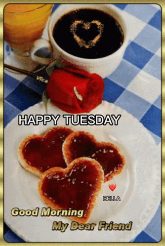 a happy tuesday greeting with a heart shaped cookie on a plate