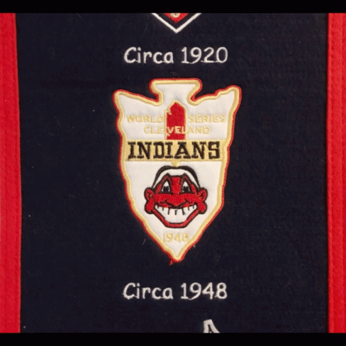 A Hat Hanging On A Door With A Cleveland Indians Banner GIF