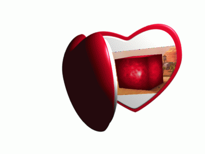 A Heart Shaped Mirror With A Desert Scene On It GIF