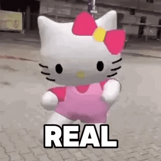 A Hello Kitty Doll Is Walking Down A Street With The Word Real Written On It . GIF
