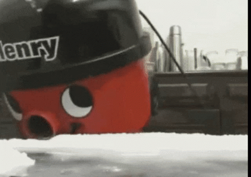 A Henry Vacuum Cleaner Is Sitting On A Kitchen Counter GIF
