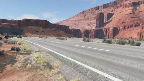 A Highway With A Tunnel In The Background And Mountains In The Background GIF