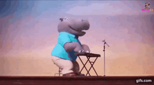 A Hippopotamus Is Playing A Keyboard And Singing Into A Microphone GIF