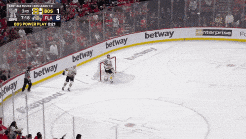 A Hockey Game Is Being Played And The Betting Advertisements Are On The Ice GIF