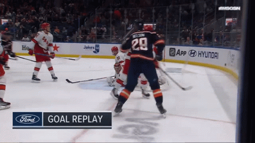 A Hockey Game Is Being Played And The Goal Replay Is Displayed On The Screen GIF