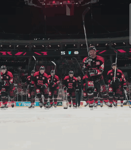 A Hockey Game Is Being Played In A Stadium With A Banner For Sauss GIF