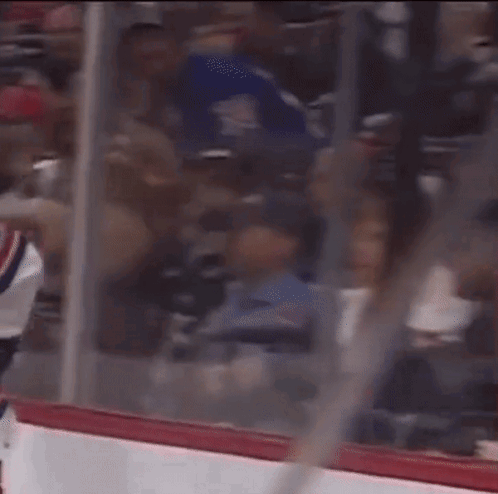 A Hockey Game Is Being Played In A Stadium With A Lot Of People In The Stands GIF