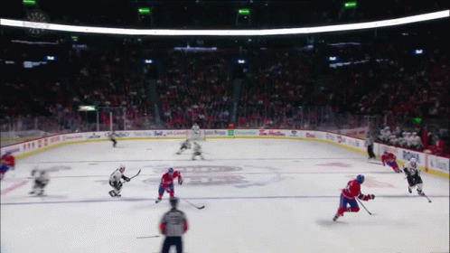 A Hockey Game Is Being Played In A Stadium With Advertisements For Tim Hortons And Budweiser GIF