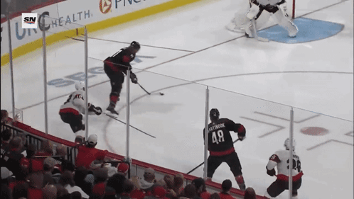 A Hockey Game Is Being Played In Front Of A Banner For Sn Health GIF