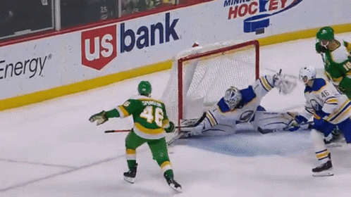 A Hockey Game Is Being Played In Front Of A Banner For Us Bank GIF