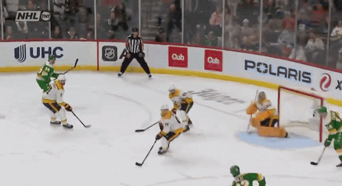 A Hockey Game Is Being Played In Front Of A Banner That Says Polaris GIF