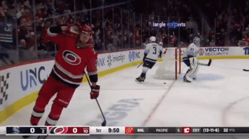 A Hockey Game Is Being Played In Front Of A Banner That Says Vector Security GIF
