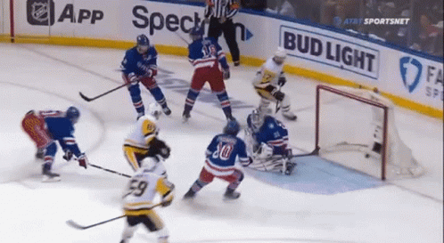 A Hockey Game Is Being Played In Front Of A Bud Light Sign GIF