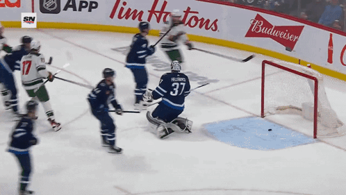 A Hockey Game Is Being Played In Front Of A Budweiser Banner GIF