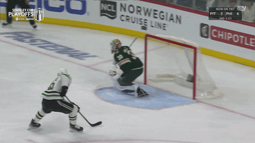 A Hockey Game Is Being Played In Front Of A Chipotle Advertisement GIF