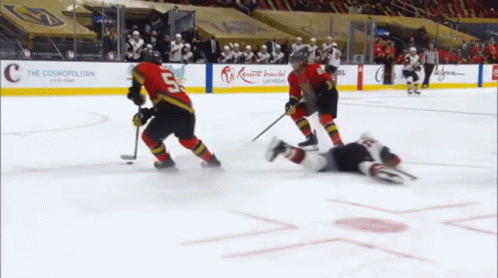 A Hockey Game Is Being Played In Front Of A Cosmopolitan Sign GIF