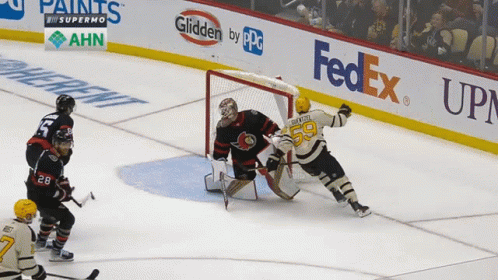 A Hockey Game Is Being Played In Front Of A Fedex Sign GIF