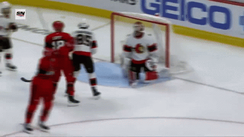 A Hockey Game Is Being Played In Front Of A Geico Advertisement GIF