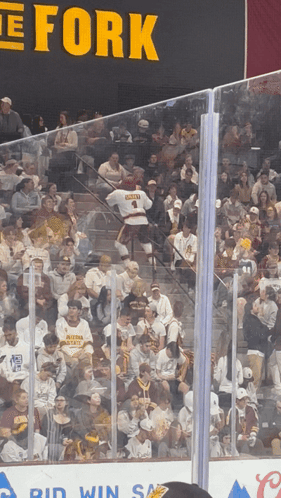 a hockey game is being played in front of a large sign that says the fork