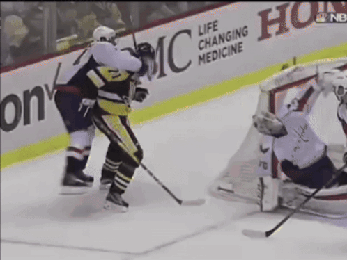 a hockey game is being played in front of a life changing medicine sign