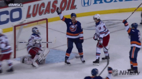 A Hockey Game Is Being Played In Front Of A Lucas Oil Sign GIF