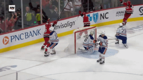 A Hockey Game Is Being Played In Front Of A Pnc Bank Advertisement GIF