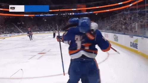A Hockey Game Is Being Played In Front Of A Screen That Says Dime On It GIF