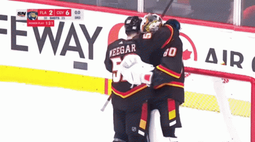 A Hockey Game Is Being Played In Front Of A Sign That Says Eway GIF