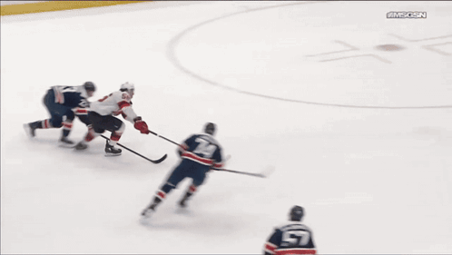 A Hockey Game Is Being Played In Front Of A Sign That Says Te-Syrup GIF