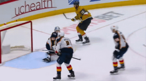 A Hockey Game Is Being Played In Front Of A Uchealth Banner GIF