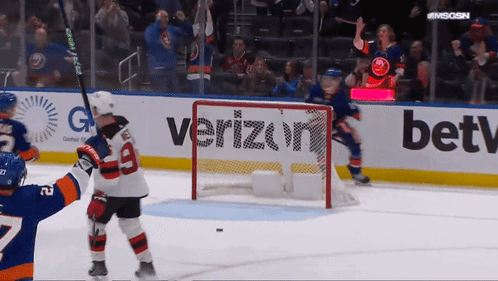 A Hockey Game Is Being Played In Front Of A Verizon Sign GIF