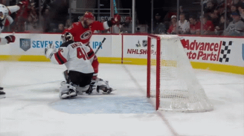 A Hockey Game Is Being Played In Front Of An Ad For Advanced To Parts GIF