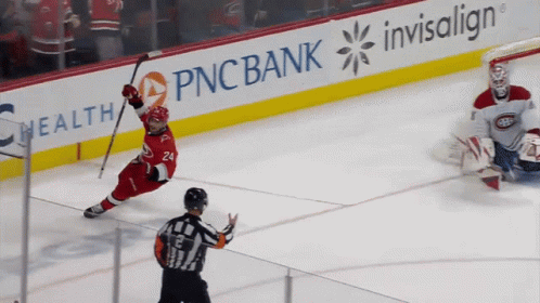 A Hockey Game Is Being Played In Front Of An Ad For Pnc Bank GIF