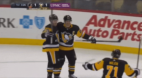 A Hockey Game Is Being Played In Front Of An Advance Auto Parts Ad GIF