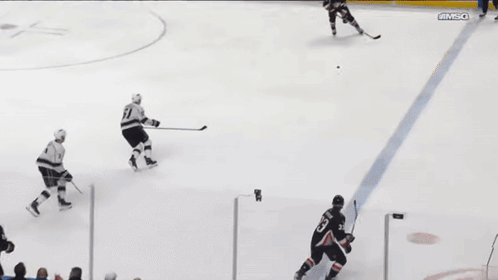 A Hockey Game Is Being Played In Front Of An Austin Air Sign GIF